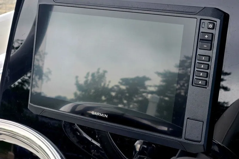 Slide: The Image of Garmin display on 2024 Tidewater 210 LXF boat dashboard, featuring control buttons. - 4