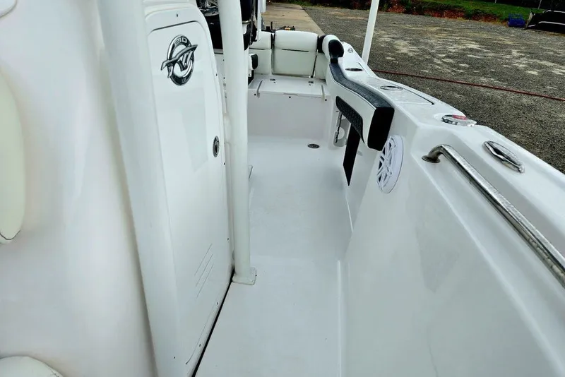 Slide: The Image of 2024 Tidewater 210 LXF boat interior, featuring sleek white design and comfortable seating. - 2