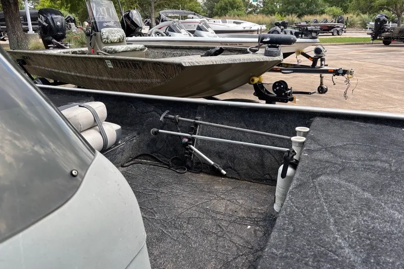 Slide: The Image of 2012 Tracker Pro 165 boat interior with fishing rod holders and equipment. - 26