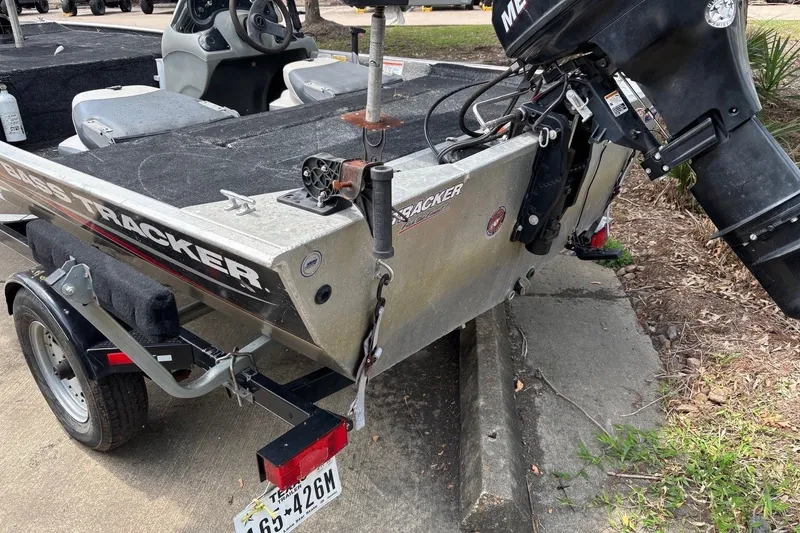 Slide: The Image of 2012 Tracker Pro 165 boat with motor, parked on a trailer, outdoor setting. - 17