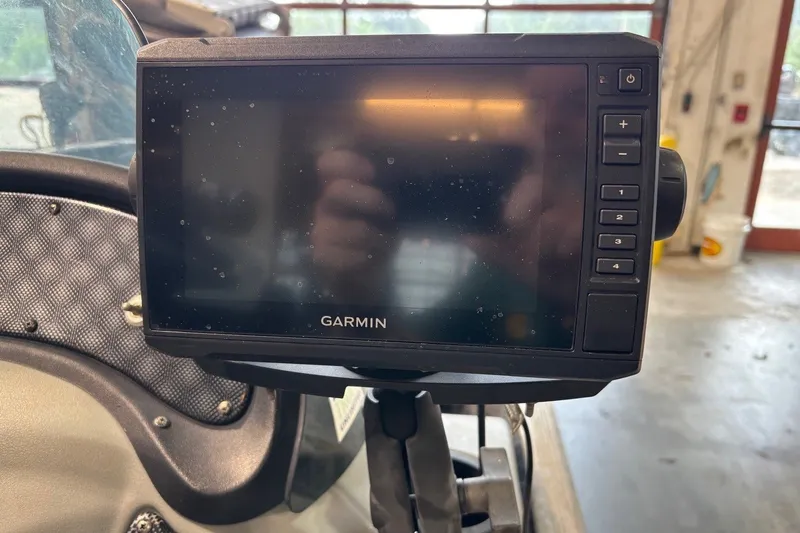 Slide: The Image of Garmin GPS device mounted on a 2012 Tracker Pro 165 boat dashboard. - 29
