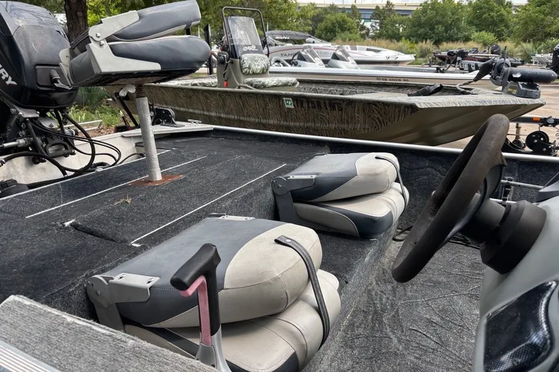 Slide: The Image of 2012 Tracker Pro 165 boat interior with seating and steering wheel. - 27