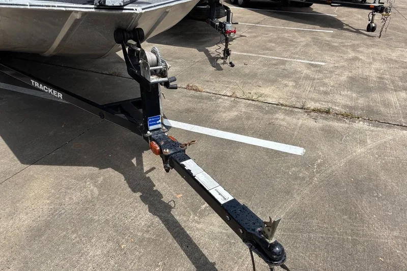 Slide: The Image of Trailer hitch of a 2012 Tracker Pro 165 boat in a parking lot. - 22