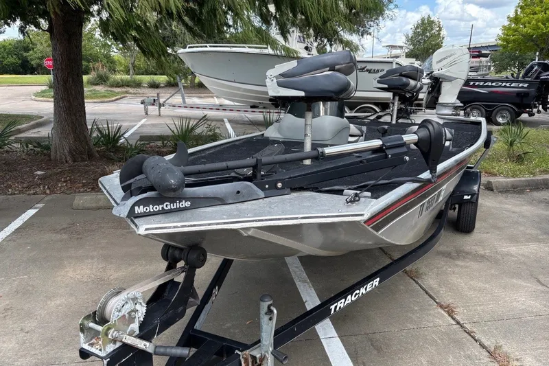 Slide: The Image of 2012 Tracker Pro 165 fishing boat with MotorGuide trolling motor in parking lot. - 68