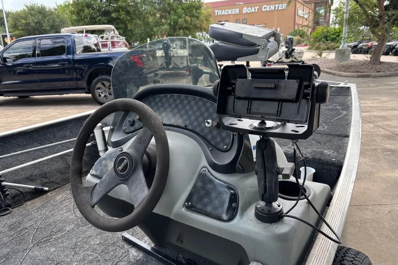 Slide: The Image of 2012 Tracker Pro 165 boat dashboard with steering wheel and mounted device at Tracker Boat Center. - 28