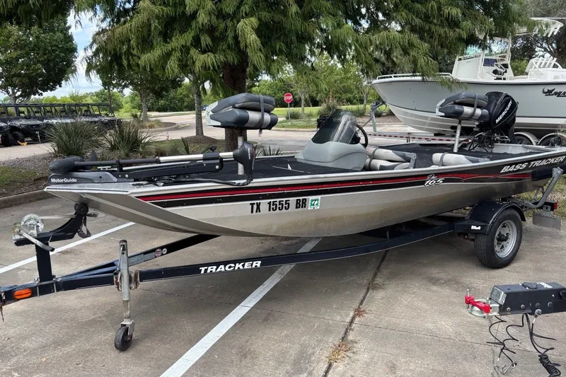 Slide: The Image of 2012 Tracker Pro 165 fishing boat on trailer, parked outdoors. - 24