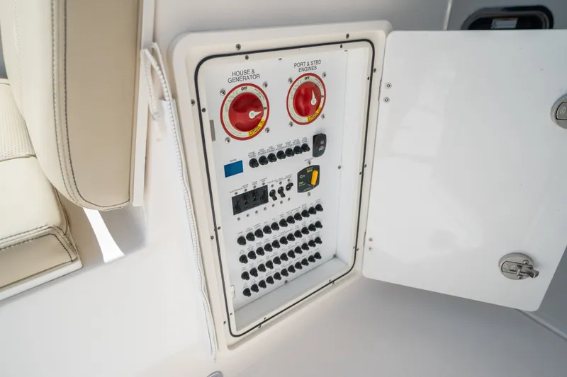 Slide: The Image of Electrical panel on a 2018 Pursuit DC 325 Dual Console boat, featuring switches and controls. - 19