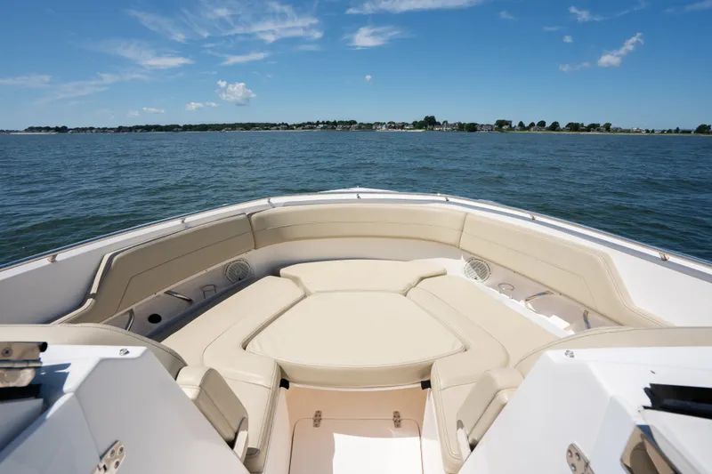 Slide: The Image of 2018 Pursuit DC 325 Dual Console boat with spacious seating on open water. - 21