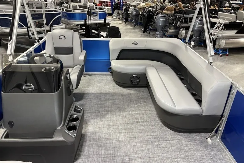 Slide: The Image of 2027 Sun Tracker Party Barge 16 DLX interior with gray seating and modern helm. - 18