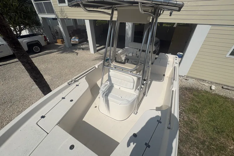 Slide: The Image of 2015 Bulls Bay 2200 boat with center console, parked outdoors near a house. - 8