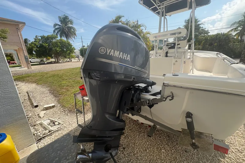 Slide: The Image of 2015 Bulls Bay 2200 boat with Yamaha outboard motor, parked outdoors. - 4