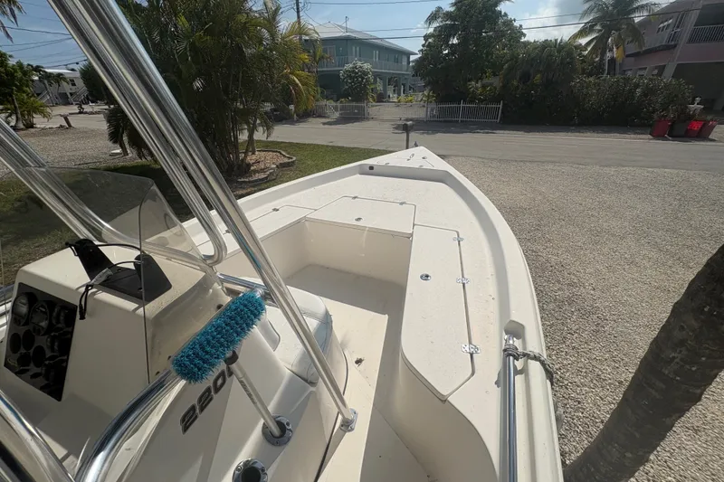 Slide: The Image of 2015 Bulls Bay 2200 boat parked on gravel driveway, surrounded by tropical foliage. - 10