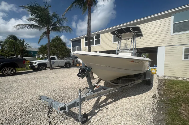 Slide: The Image of 2015 Bulls Bay 2200 boat on trailer, parked in a sunny driveway with palm trees. - 7