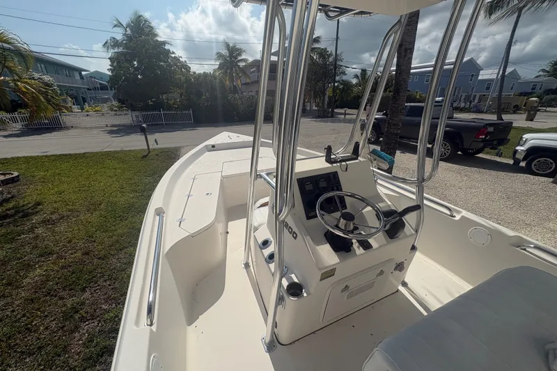 Slide: The Image of 2015 Bulls Bay 2200 boat with center console and steering wheel, parked outdoors. - 9