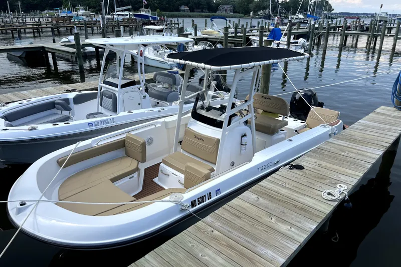 The Image of 2024 Trophy CC22 boat docked at marina, featuring sleek design and comfortable seating. - 2