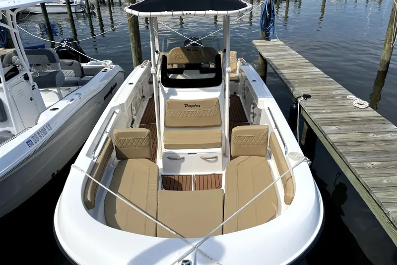 Slide: The Image of 2024 Trophy CC22 boat docked, featuring spacious seating and sleek design. - 1