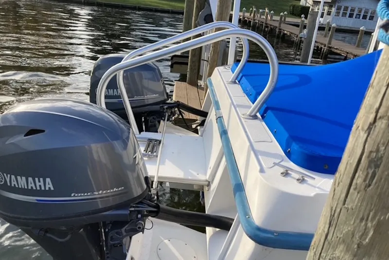 Slide: The Image of 1998 Kevlacat Series 2000 Cuddy Cabin OB with Yamaha outboard motors docked by water. - 9