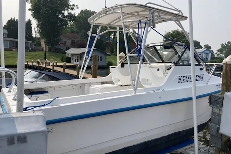 Slide: The Image of 1998 Kevlacat Series 2000 Cuddy Cabin OB docked at a marina. - 4