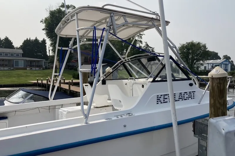 Slide: The Image of 1998 Kevlacat Series 2000 Cuddy Cabin OB docked at a marina. - 5