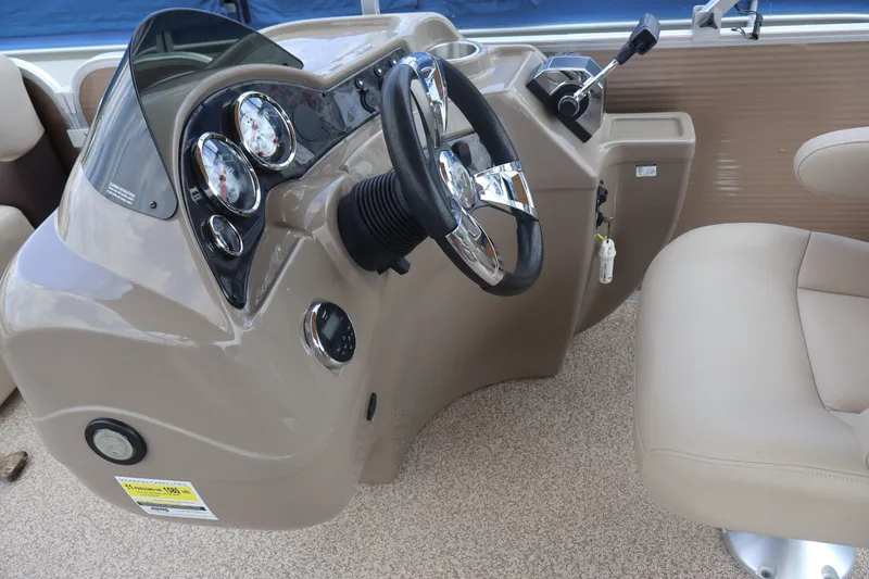 Slide: The Image of Steering console of 2015 Palm Beach Ultra Sport 220 RL boat with beige seating. - 29