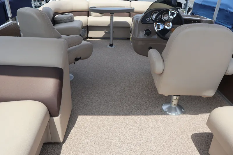 Slide: The Image of Interior of 2015 Palm Beach Ultra Sport 220 RL boat with beige seating and steering console. - 33