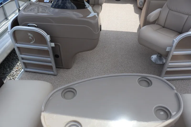 Slide: The Image of Interior of 2015 Palm Beach Ultra Sport 220 RL pontoon boat with beige seating and table. - 28