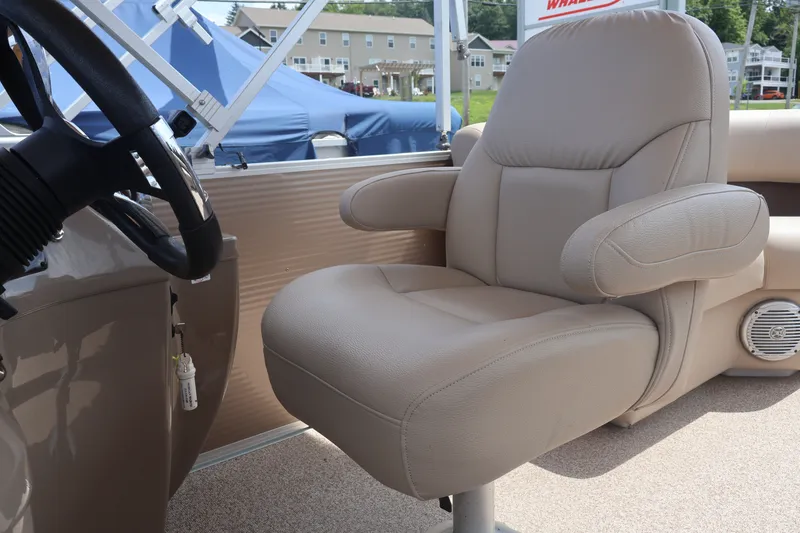 Slide: The Image of Captain's chair on 2015 Palm Beach Ultra Sport 220 RL boat, featuring beige upholstery. - 31