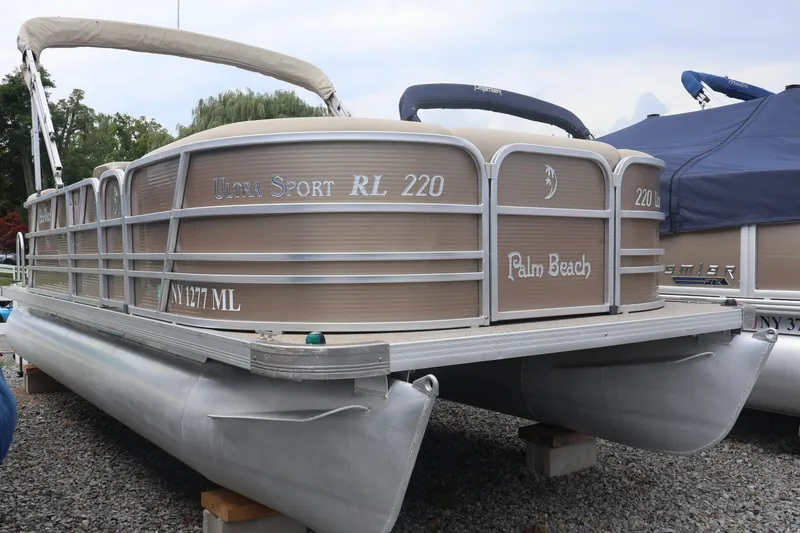 The Image of 2015 Palm Beach Ultra Sport 220 RL pontoon boat on display outdoors. - 0