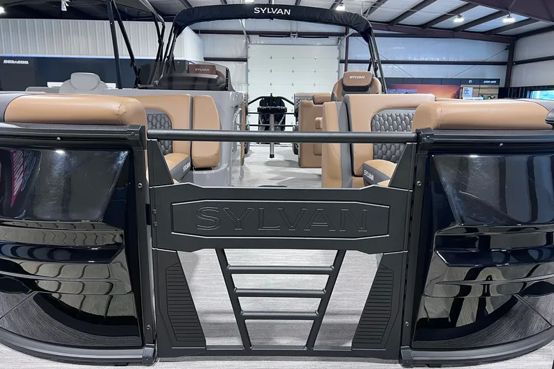 Slide: The Image of 2026 Sylvan L3 LZ DH pontoon boat with luxurious seating and sleek design in showroom. - 2