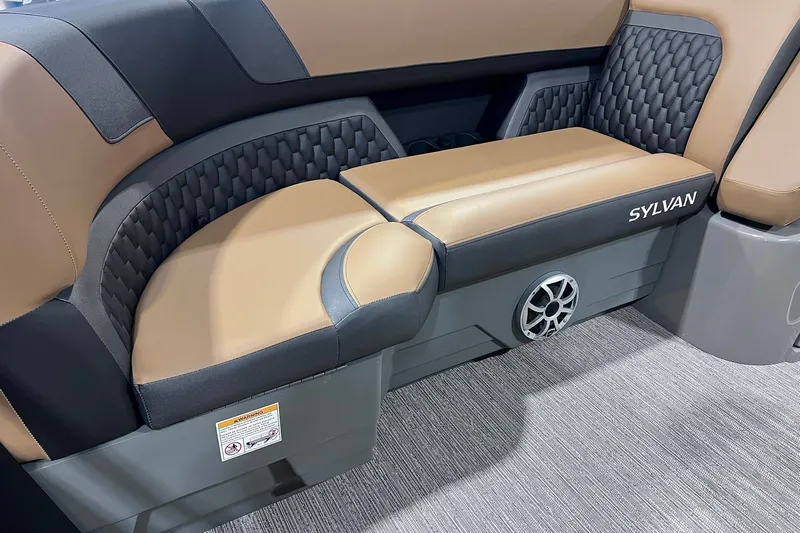 Slide: The Image of 2026 Sylvan L3 LZ DH boat interior with tan and black seating, featuring a speaker. - 5