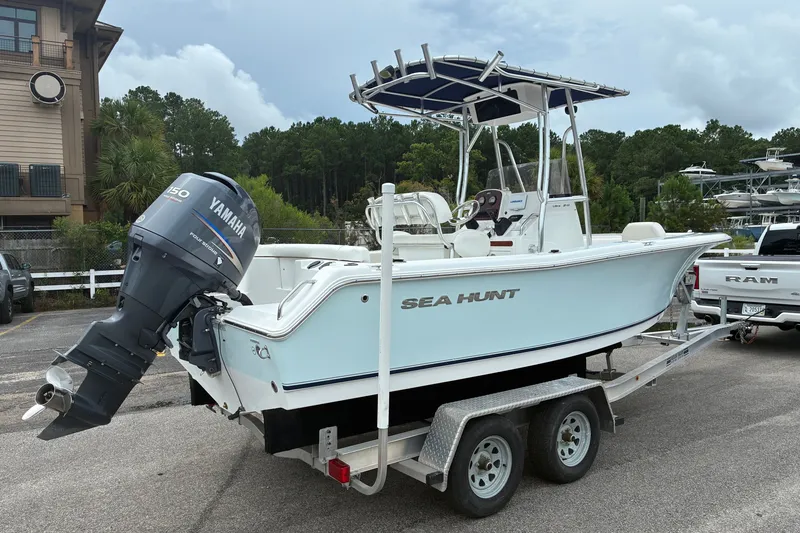 Slide: The Image of 2012 Sea Hunt Ultra 211 boat on trailer with Yamaha outboard motor in parking lot. - 18