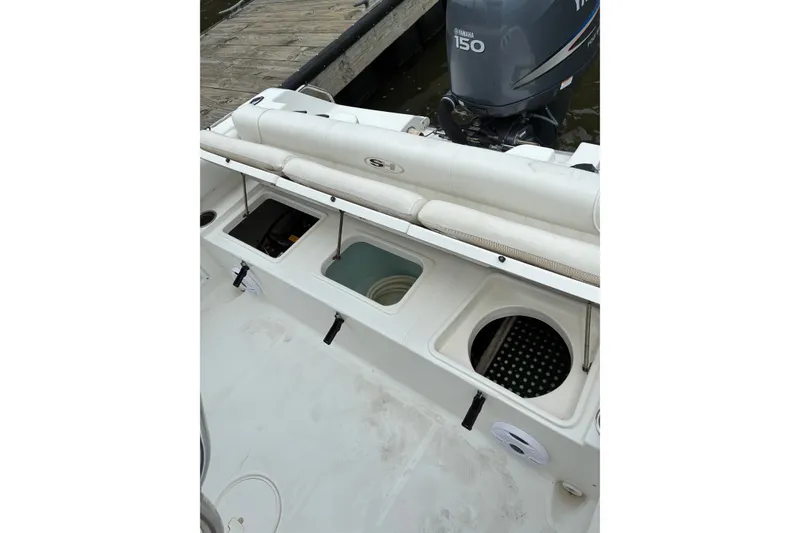 Slide: The Image of 2012 Sea Hunt Ultra 211 boat with Yamaha 150 engine, featuring storage compartments. - 15