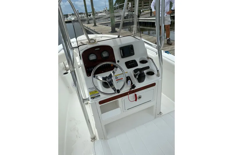 Slide: The Image of 2012 Sea Hunt Ultra 211 boat console with steering wheel and navigation controls. - 13