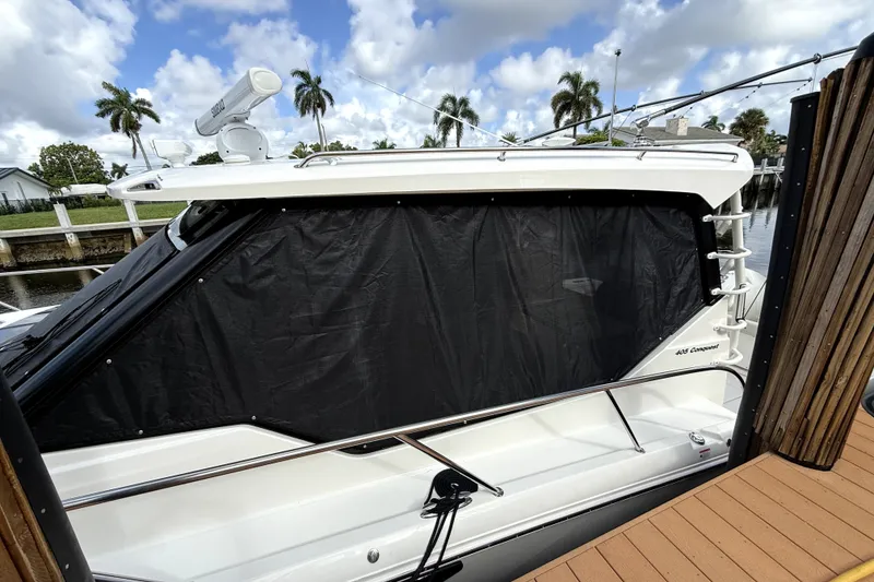 Slide: The Image of 2024 Boston Whaler 405 Conquest docked, featuring sleek design and covered windows. - 7
