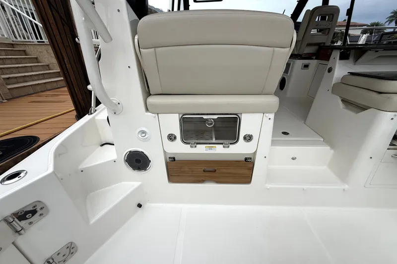Slide: The Image of 2024 Boston Whaler 405 Conquest interior, featuring seating and storage compartments. - 21