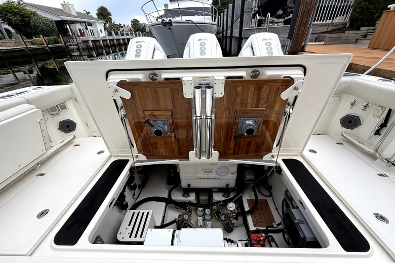 Slide: The Image of 2024 Boston Whaler 405 Conquest engine compartment with open hatch, showcasing mechanical components. - 10
