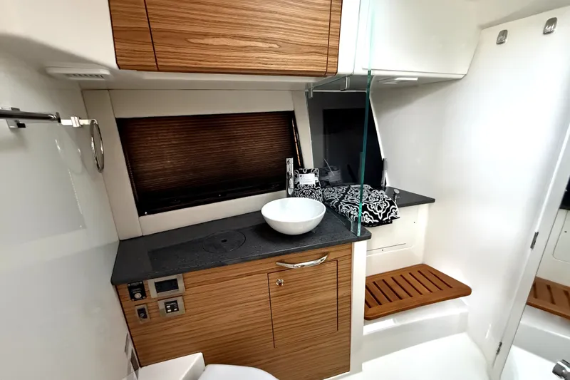 Slide: The Image of Luxurious interior of 2024 Boston Whaler 405 Conquest, featuring modern wood cabinetry and sleek design. - 12