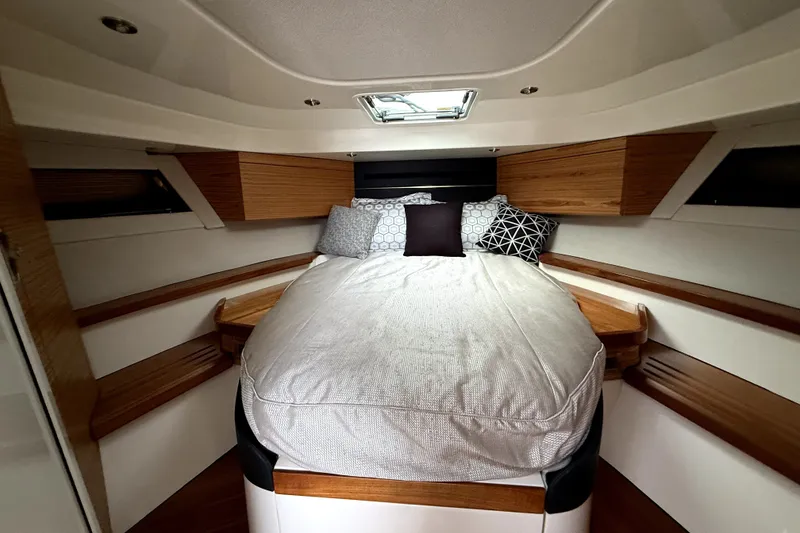 Slide: The Image of Luxurious cabin interior of 2024 Boston Whaler 405 Conquest with cozy bedding and modern design. - 13