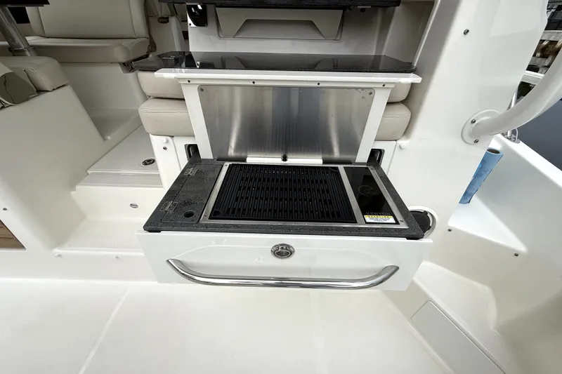 Slide: The Image of Outdoor grill station on 2024 Boston Whaler 405 Conquest boat, featuring sleek design and functionality. - 25