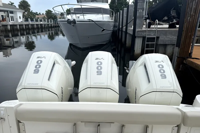 Slide: The Image of 2024 Boston Whaler 405 Conquest with triple Mercury 600 V12 engines docked. - 3