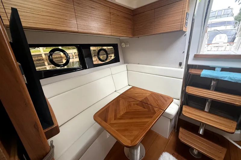 Slide: The Image of Luxurious interior of 2024 Boston Whaler 405 Conquest with elegant wood and white seating. - 14