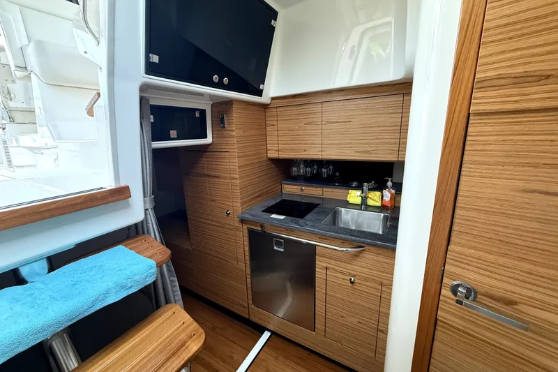 Slide: The Image of Luxurious 2024 Boston Whaler 405 Conquest yacht interior with modern kitchen amenities. - 22