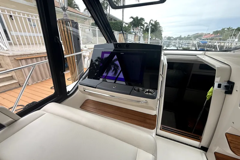 Slide: The Image of 2024 Boston Whaler 405 Conquest interior with modern dashboard and seating. - 16