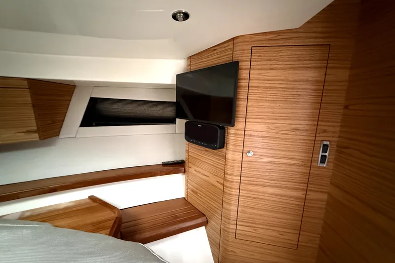 Slide: The Image of Interior of 2024 Boston Whaler 405 Conquest with wood paneling and mounted TV. - 17