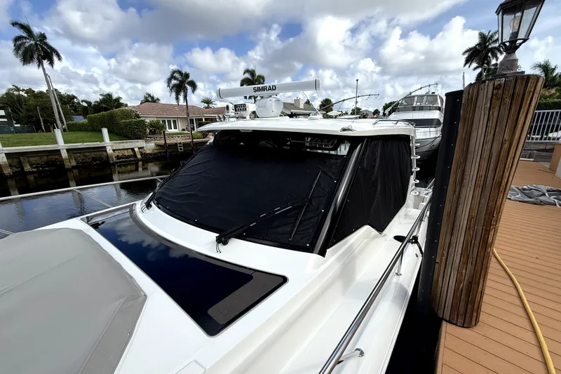 Slide: The Image of 2024 Boston Whaler 405 Conquest docked, featuring sleek design and advanced navigation equipment. - 8