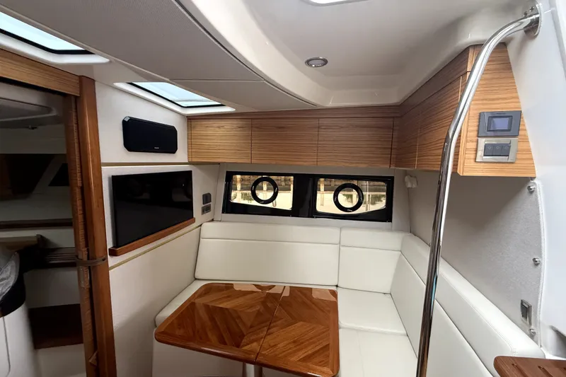 Slide: The Image of Luxurious interior of 2024 Boston Whaler 405 Conquest with elegant seating and wood accents. - 24