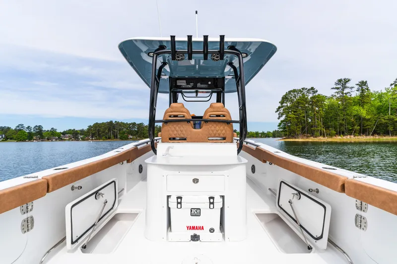 Slide: The Image of 2026 Sea Hunt Ultra 305SE boat interior with dual seats, lake view, and Yamaha equipment. - 21