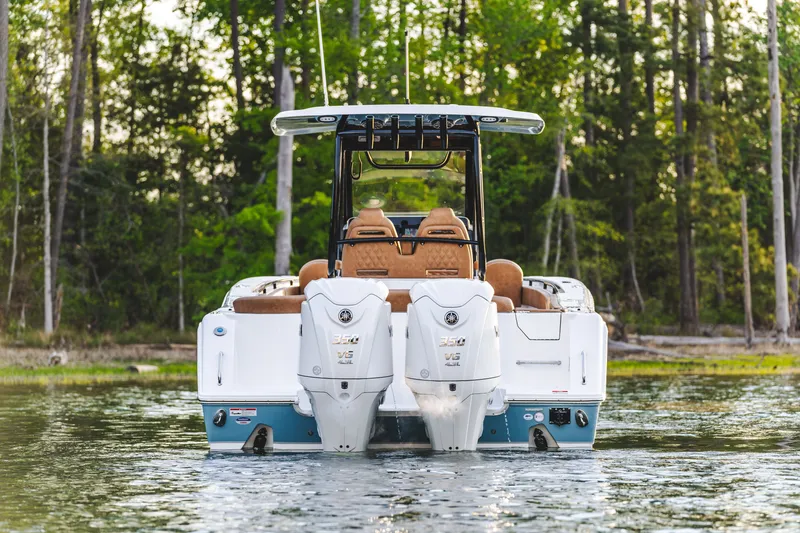 Slide: The Image of 2026 Sea Hunt Ultra 305SE boat with dual engines on a serene lake. - 7