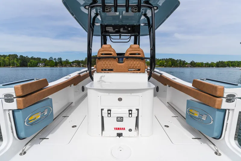 Slide: The Image of 2026 Sea Hunt Ultra 305SE boat interior with tan seating and Yamaha cooler. - 24