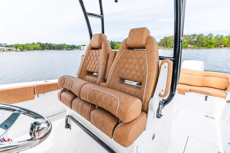 Slide: The Image of Luxurious seating on 2026 Sea Hunt Ultra 305SE boat with scenic water backdrop. - 15